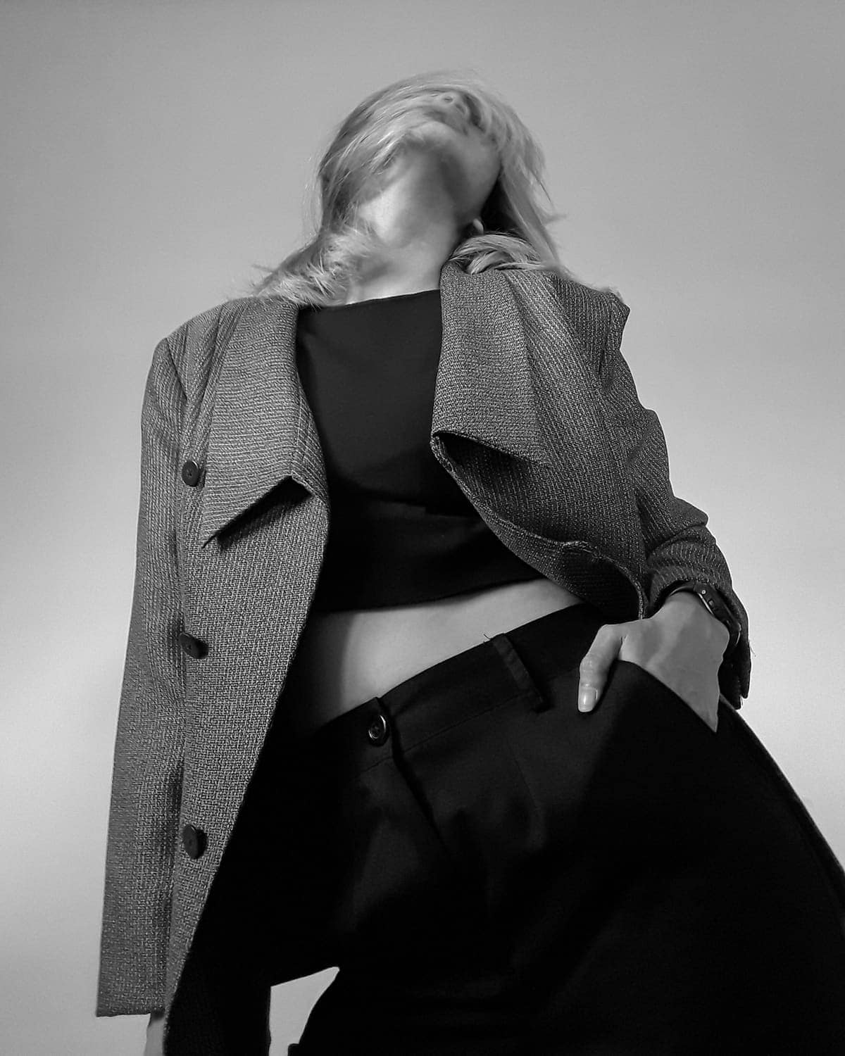 Grey wool blazer over a black top, black and white