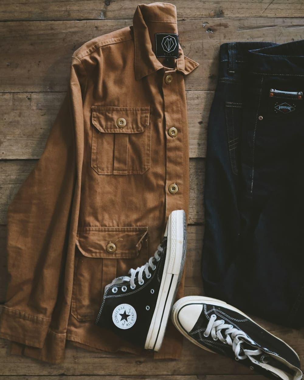 Brown overshirt with black jeans and canvas sneakers