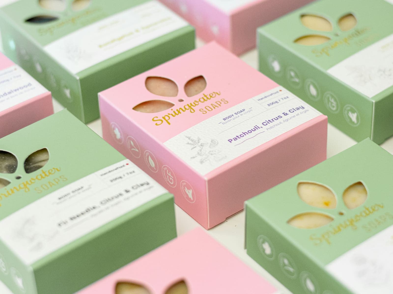 Pastel green and pink boxes with a cut-out flower pattern